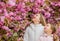 Botany concept. Kids enjoying cherry blossom sakura. Flowers soft pink clouds. Children enjoy warm spring. Girls posing