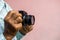 Both hands of an elderly Thai man holding an old film camera.