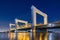 Botlek bridge, Rotterdam, Netherlands. View of the bridge at night. Road for cars and railroad transport. Architectural landscape.