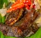 Botok lele, fried catfish served with spicy curry and wrapped with banana leaf.