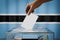 Botswana flag, hand dropping ballot card into a box - voting, election concept