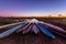 Botswanian local mokoro boats in the sunset time, on the shore of delta Okavango river, Botswana