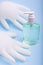 Bottle of alcohol hand gel sanitizer and pair of latex medical hand gloves.