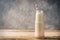 Bottle with alternative milk on rustic background