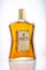 Bottle of Amaretto liqueur on gradient background.