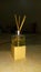 Bottle of aromatic scent with sticks in it isolated on wooden cube,luxury lifestyle, spa liquid