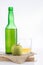 Bottle of Asturian cider with glass and apple on white background