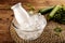 A bottle of AYRAN YOGHURT DRINK served in iced cube bowl side view on grey background