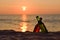 Bottle of beer on the beach at sunset