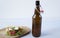 A bottle of beer and Pita - a sandwich, sabiche stuffed with chicken, sauce, tomatoes, cucumbers and salad on a white background.