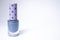 A bottle with blue nail polish on white background. nail lacquer. Nail manicure concept. Isolated, copy space