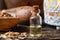 A bottle of cedar essential oil with pieces of cedar wood
