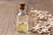 A bottle of cedar essential oil with pieces of cedar wood
