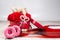 Bottle of champagne, box with red roses ,rustic ribbon, donuts on a wooden surface. Festive congratulations background