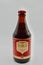 A bottle of Chimay brown against a white background