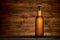 Bottle of cold beer on wooden table background