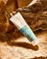 Bottle of cosmetic lotion, sunscreen on the background of nature, stone, wood texture. Natural cosmetics.