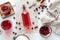 A bottle of cranberry juice next to a bowl of cranberries, homemade cranberry wine