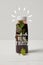 bottle of detox smoothie with mint on white wooden surface, made with real fruits inscription