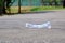 A bottle of drinking water littering on a road ground floor at the green park for an environmental cleaning concept