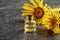A bottle of elecampane essential oil with fresh elecampane flowers