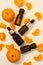 A bottle of essential oil, Aromatic tangerine oil in a dark bubble, cosmetic oil from tangerine. Bottles with sweet orange