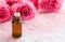 Bottle with essential oil , spa salt crystals and pink roses