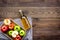 Bottle of fresh cider near autumn apples. Dark wooden background top view space for text