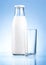 Bottle of fresh milk and blank glass on blue