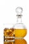 Bottle and glass with alcoholic drink with ice, on the rocks, whisky, rum, cognac, brandy, scottish, white background