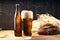 Bottle and glass of beer. Beer and wheat. Wheat and black bread on a wood background. Beer screensaver. Rural style