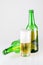 Bottle and glass of beer on a white background. Large malt cold drink.