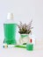 Bottle and glass of mouthwash on bath shelf with toothbrush. Dental oral hygiene concept. Set of oral care products