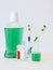 Bottle and glass of mouthwash on bath shelf with toothbrush. Dental oral hygiene concept. Set of oral care products