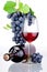 Bottle and glass of red wine, bunch of grapes with leaves isolated on white background