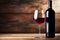 Bottle and a glass of red wine on rustic wooden background, wine tasting and winery, post-processed, generative ai