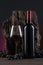 Bottle, glass of Spanish red wine and grapes on  wooden base on black and red background