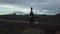 Bottle and glass of wine, overlooking Malibu Mountains and vineyard, dark rain clouds, rising view