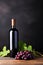 Bottle and glass of wine  on a rustic black background. Copy space for your text