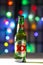 A Bottle of Green bottle dos equis Beer. A Mexican beer on a white texture surface on a colourful defocused lights.