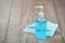 Bottle of Hand sanitizer blue gel alcohol with Disposable face mask