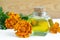 Bottle of healing marigold oil (Tagetes flowers extract, tincture, infusion)