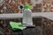 A bottle of hob cleaner, cooker cleaning scraper and a green jay cloth on a cooker in a kitchen. Chores and domestic