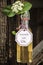 Bottle with homemade elderflower syrup on an old wood truss