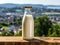 Bottle of homemade village milk against the backdrop of the village. AI