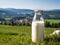 Bottle of homemade village milk against the backdrop of the village. AI