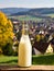 Bottle of homemade village milk against the backdrop of the village. AI