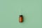 Bottle of homeopathic granules on green background. Homeopathy medicine.