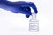 Bottle of hydrochloric acid, handling with glove for chemist, chemical solution used in the industry in general, toxic and