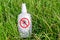 Bottle of insect repellent lying in the grass